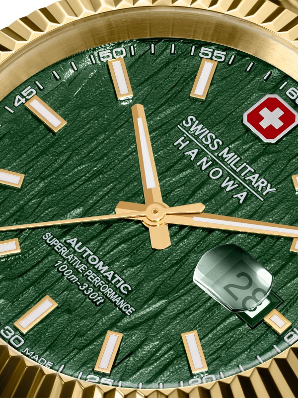 SWISS MILITARY HANOWA MASTER DILIGENTER SMWGL0005412 – luksuzni Swiss Made automatik sat koji spaja eleganciju i izdržljivost. Kućište od nerđajućeg čelika u boji žutog zlata (41 mm) sa žlebljenim okvirom i teksturiranim zelenim brojčanikom stvara upečatljiv kontrast. Sat pokreće precizan automatski mehanizam Soprod P024, ima safirno staklo, uvećavajuće sočivo za datum i vodootpornost do 100 metara. Idealan izbor za muškarce koji žele prestižan izgled i švajcarsku pouzdanost.