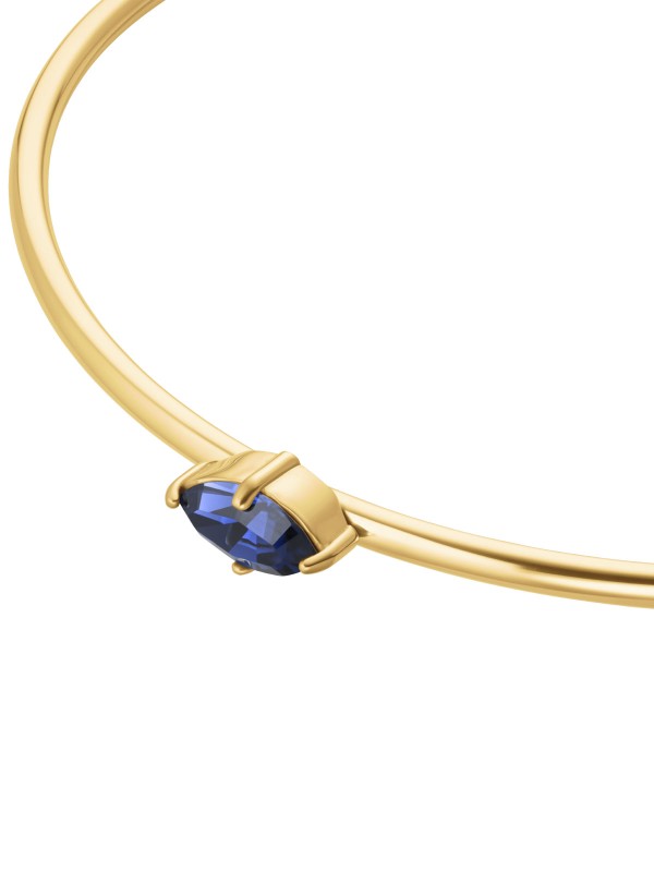 Rosefield JBMMG-J1241 – elegantna ženska narukvica od nerđajućeg čelika sa otvorenim krajevima u boji žutog zlata, ukrašena plavim cirkonom. Veličina: 6 cm x 5 cm. Idealna kombinacija elegancije i modernog dizajna.