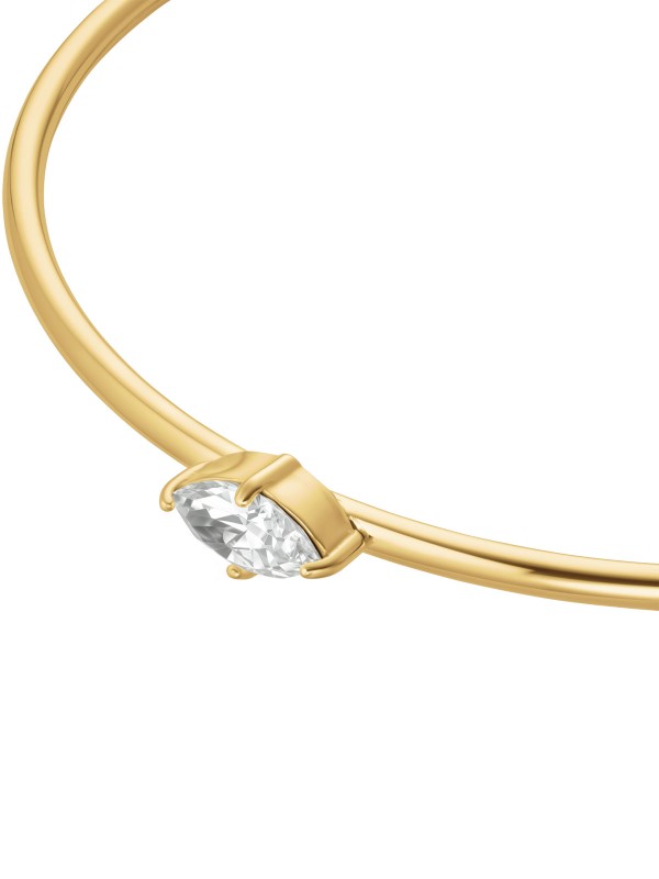 Rosefield JBCMG-J1240 – elegantna ženska narukvica od nerđajućeg čelika sa otvorenim krajevima u boji žutog zlata, ukrašena belim cirkonom. Veličina: 6 cm x 5 cm. Savršen spoj minimalizma i luksuza.