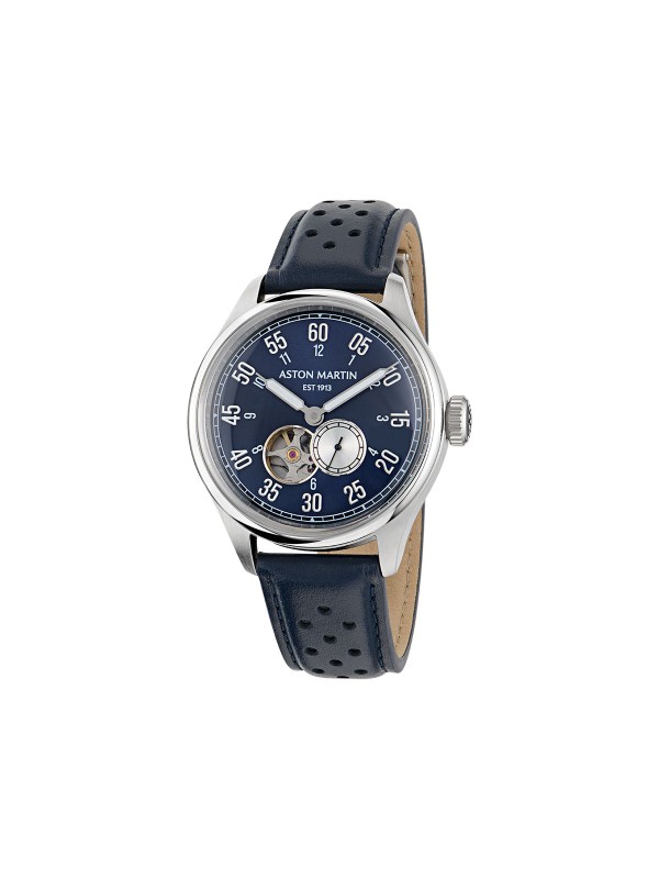 Aston Martin MTTS1F502 – luksuzni automatik sat koji kombinuje eleganciju i tehničku preciznost. Kućište od nerđajućeg čelika prečnika 41mm sadrži skeleton brojčanik u teget boji sa istorijskim logom Aston Martina iz 1913. godine. Transparentna poleđina otkriva automatski mehanizam sa rotorom u prepoznatljivoj podium zelenoj boji. Uparen sa teget kožnom narukvicom, ovaj model spaja britansku sofisticiranost i savremeni dizajn za istinske poznavaoce stila.