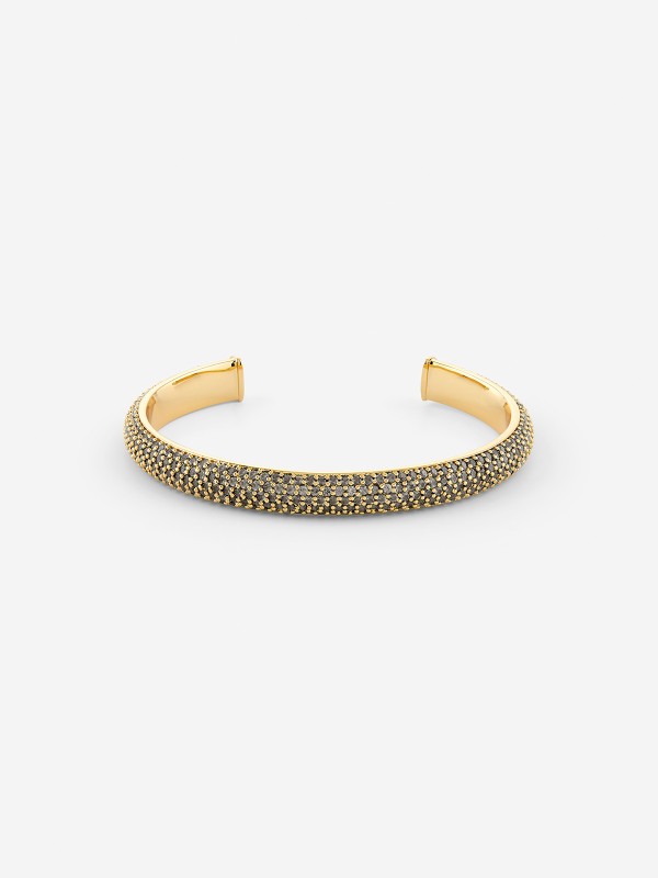 Ženska narukvica od legure metala u boji žutog zlata sa crnim cirkonima. Elegantna i čvrsta, savršena za svaku priliku. Kupite odmah online!