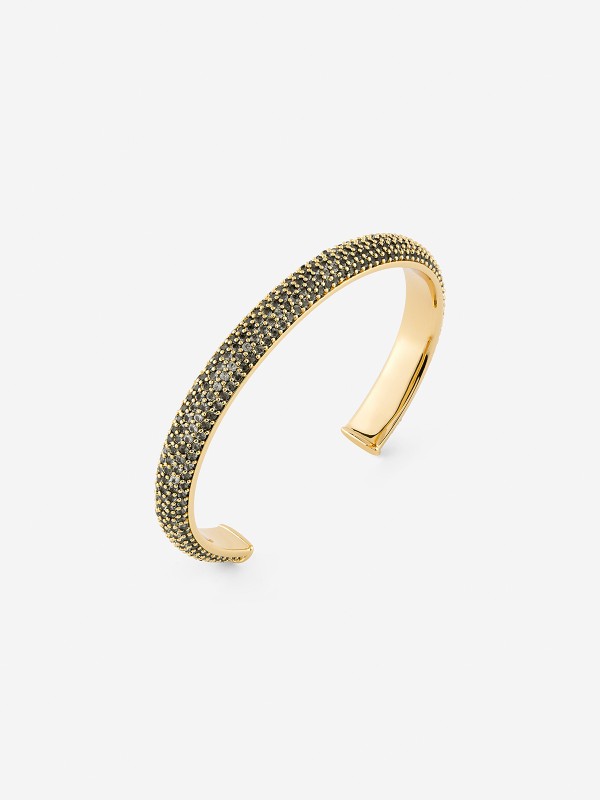 Ženska narukvica od legure metala u boji žutog zlata sa crnim cirkonima. Elegantna i čvrsta, savršena za svaku priliku. Kupite odmah online!